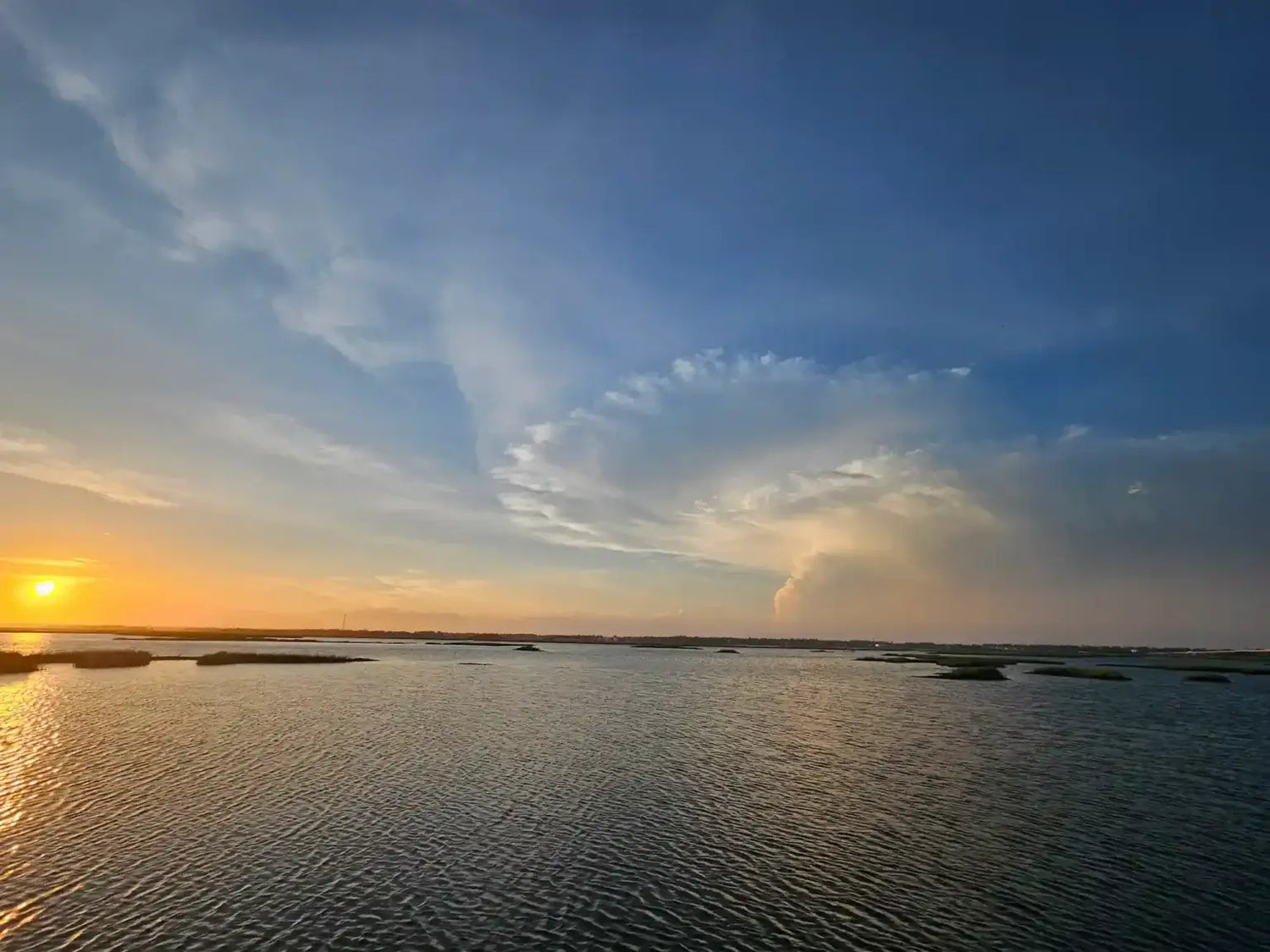 A sunset over marshes, where often foam and plastics from traditional bobbers are lost and pollute the environment.